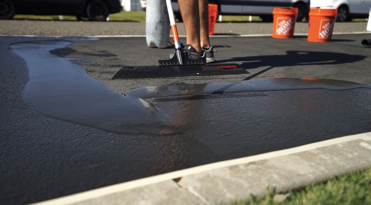 Asphalt seal coating being applied