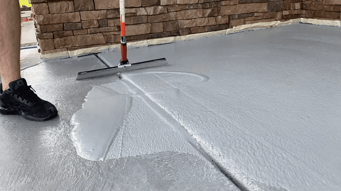 Concrete seal coat being spread across a porch