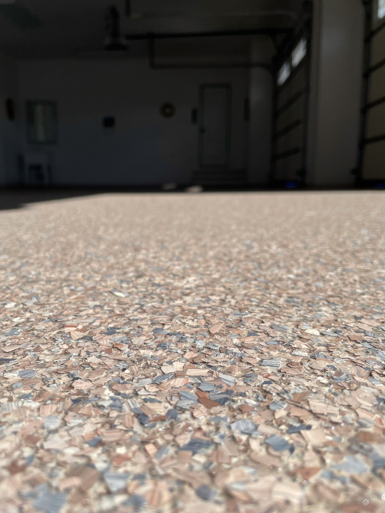 Finished vinyl flake floor beside a parked vehicle