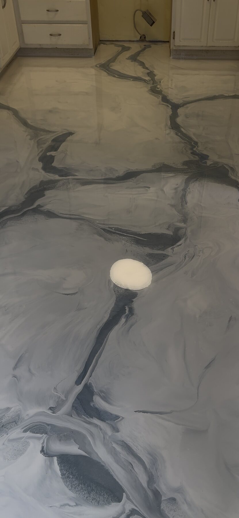 Gray and white metallic epoxy floor with flowing stone-like movement